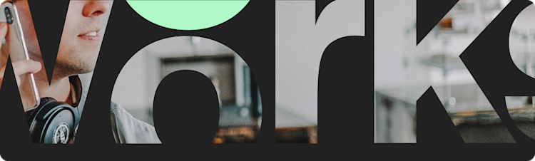 A knockout text effect showing a man working at a desk, wearing headphones around his neck while using a mobile phone.
