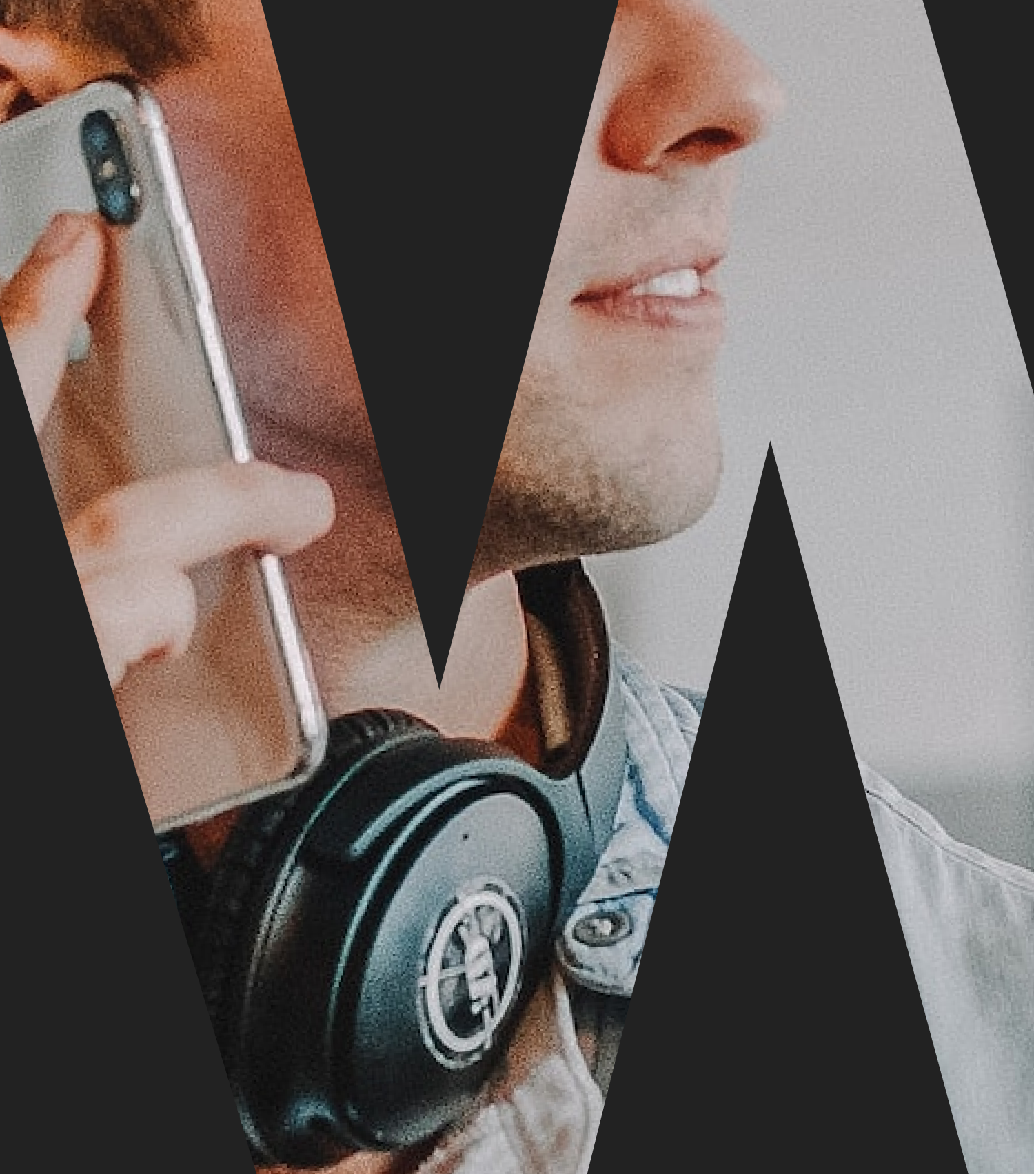 A knockout text effect showing a man working at a desk, wearing headphones around his neck while using a mobile phone.