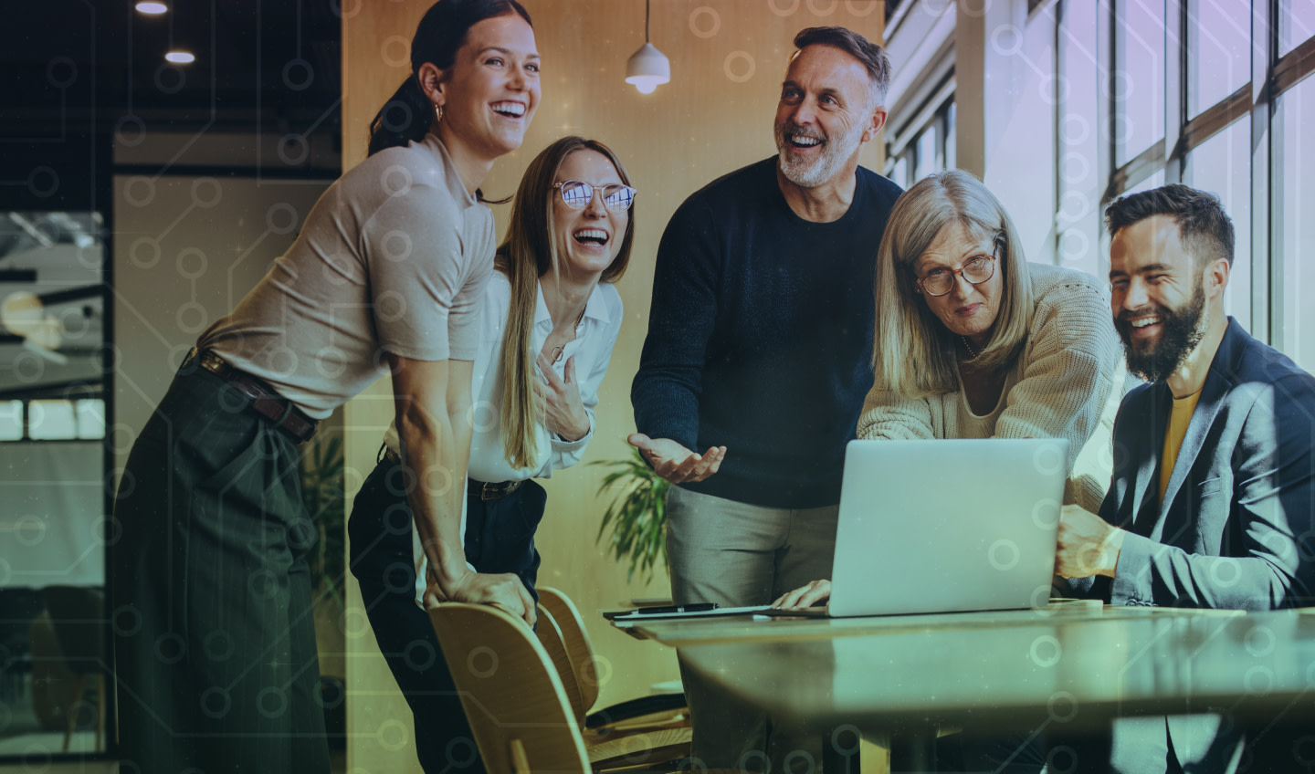 A group of happy people looking at a laptop 