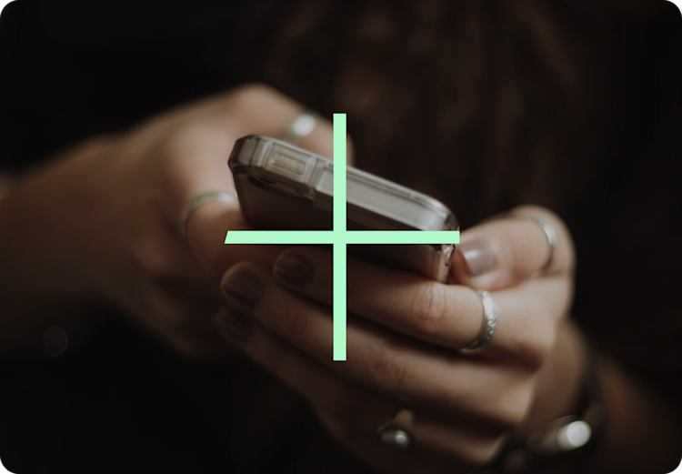 A set of hands holding a mobile phone