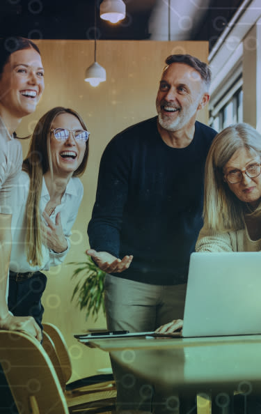 A group of happy people looking at a laptop 