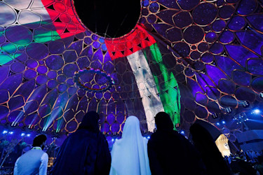 Visitors looking at the UAE flag on Al Wasl Visitors looking at the UAE flag on Al Wasl