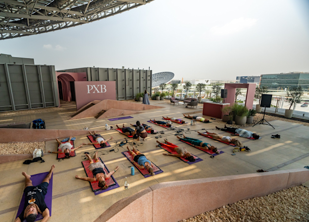 Class attendees laid on their back on mattresses