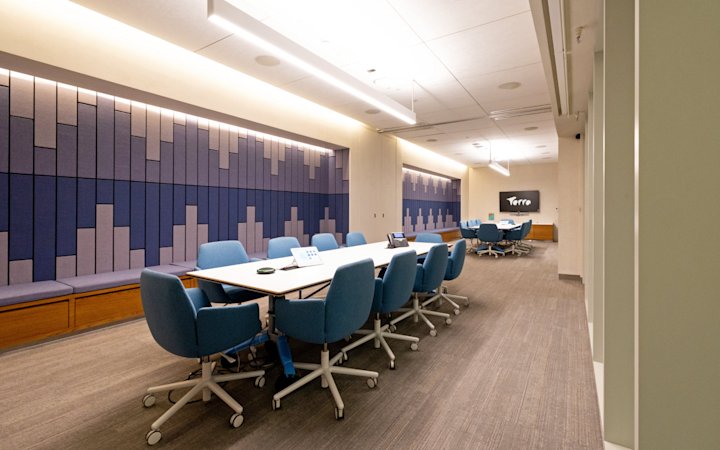 A meeting room with table for 10 people