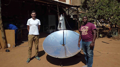 2 guys, standing next to a sterilisation device