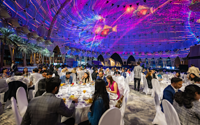 People having having dinner under Al Wasl dome