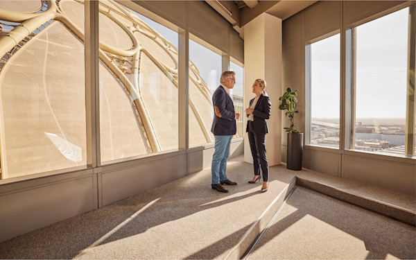 offices-gallery-al-wasl-1 Man and woman discussing topic at a top floor with AL Wasl dome almost touching the building