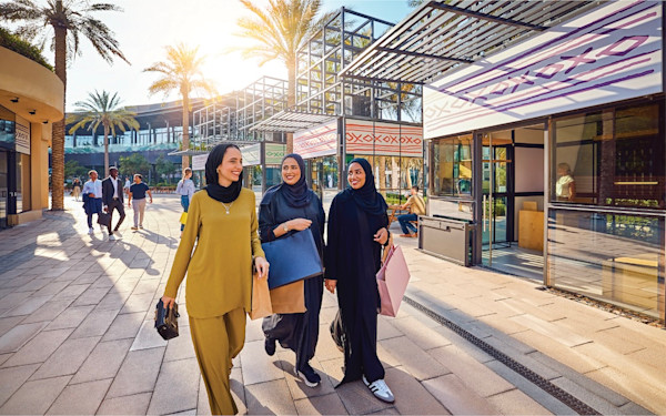 retail-FnB-spaces-gallery-2 Three women wearing headscarves smiling and walking around the koisks at Expo City Dubai