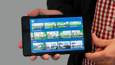 Hands holding a tab device directing it to the camera