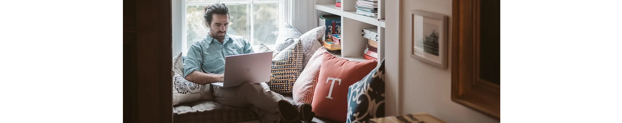 person on sofa with laptop