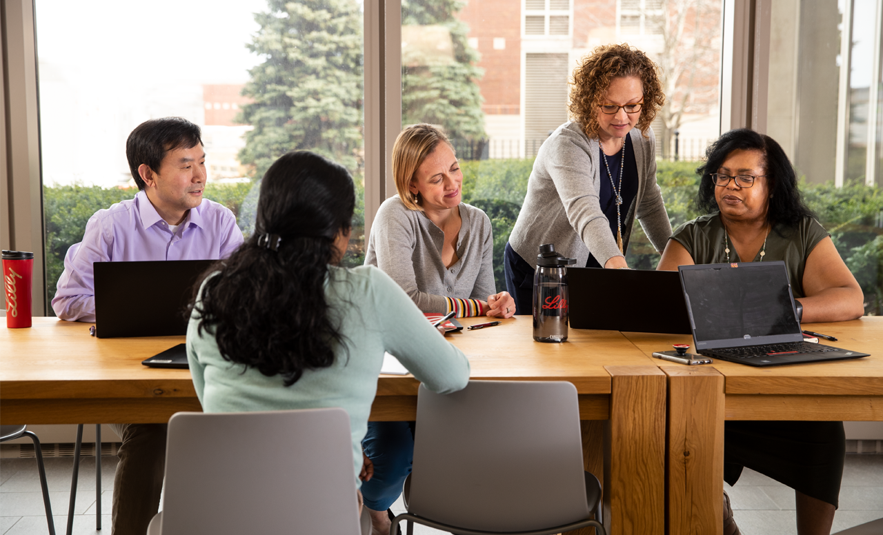 Diverse group of people collaborating around the table