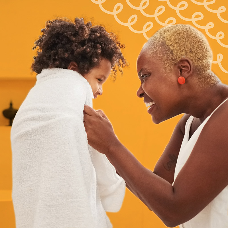 Mom drying her kid off after shower