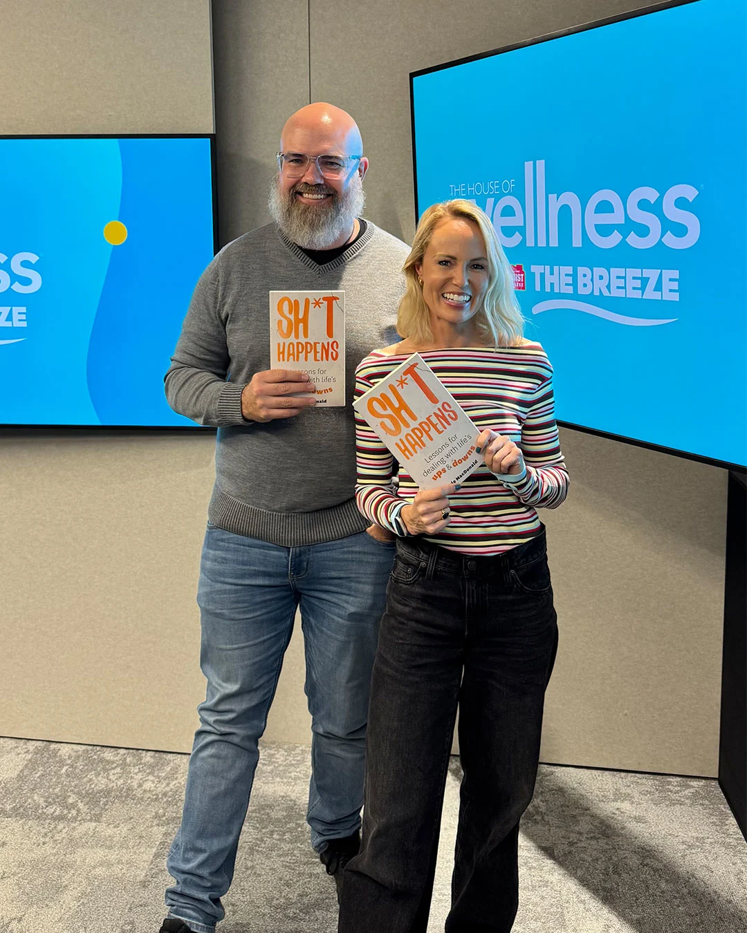Carolyn Taylor and Kyle MacDonald holding his new book