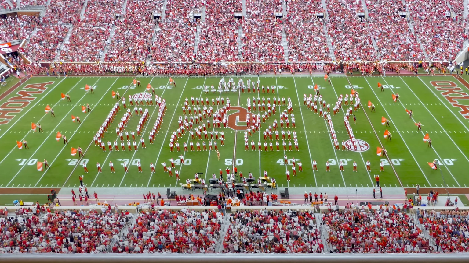 Pride of Oklahoma marching band spelling out 'OZZY' on the field