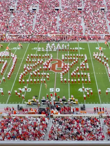 Pride of Oklahoma marching band spelling out 'OZZY' on the field