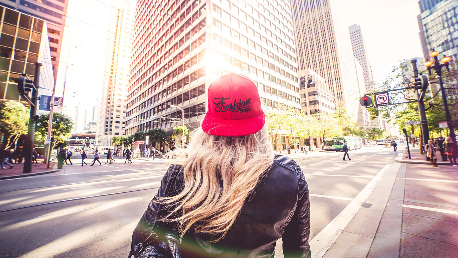 Person in red cap viewing city skyscrapers