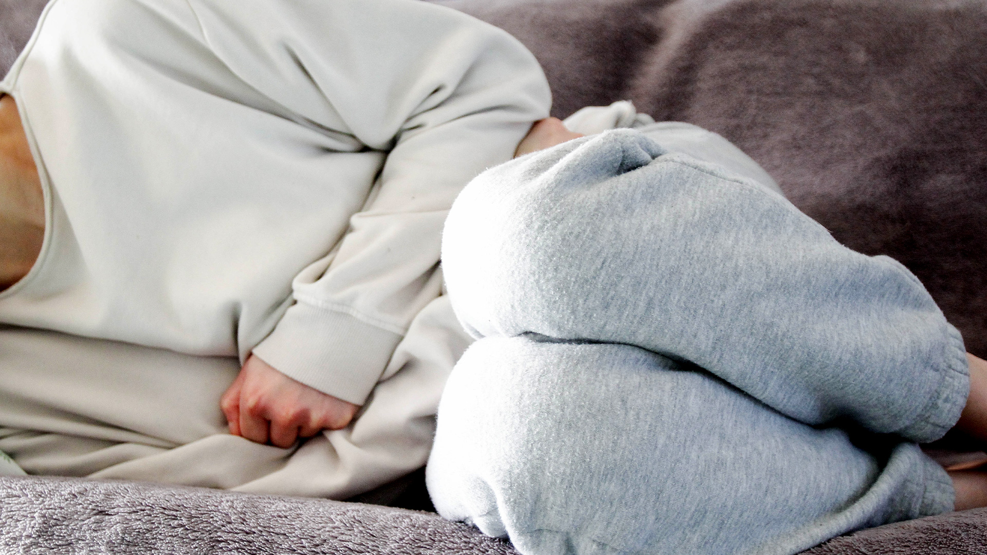 Women curled over in menstrual pain