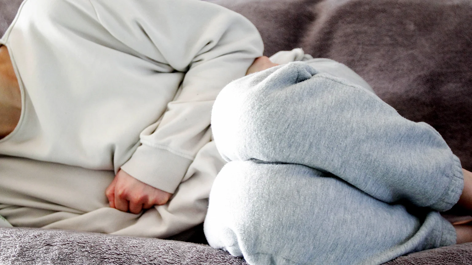 Women curled over in menstrual pain