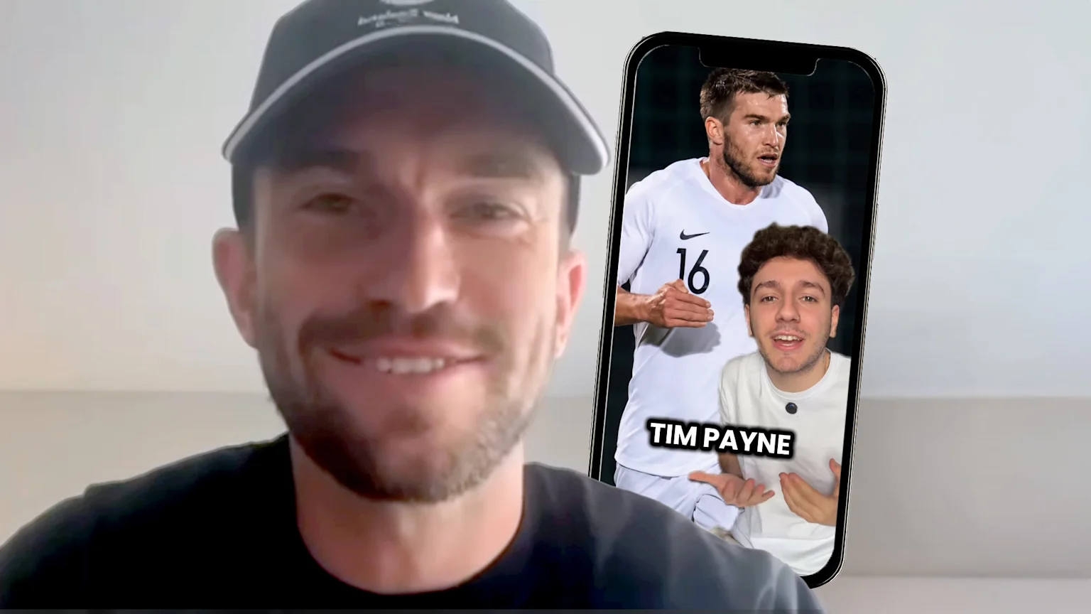 A smiling man in a black cap looks at the camera, next to a smartphone displaying a video of a footballer and a smaller man below him pointing to the text "TIM PAYNE".