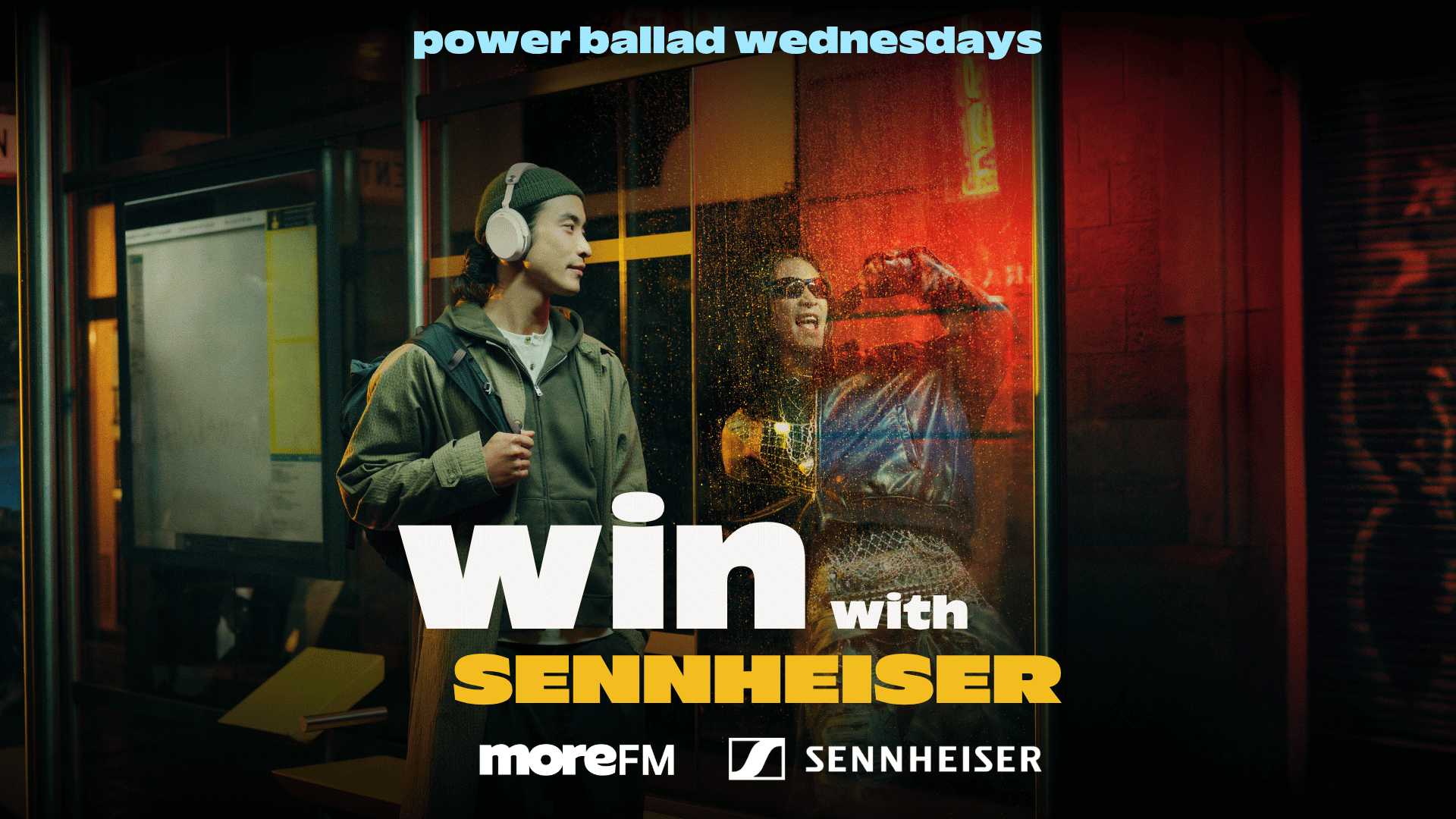 A man in Sennheiser headphones stands at a bus stop looking at an excited person behind a rainy window, with text "power ballad wednesdays" and "win with Sennheiser moreFM."