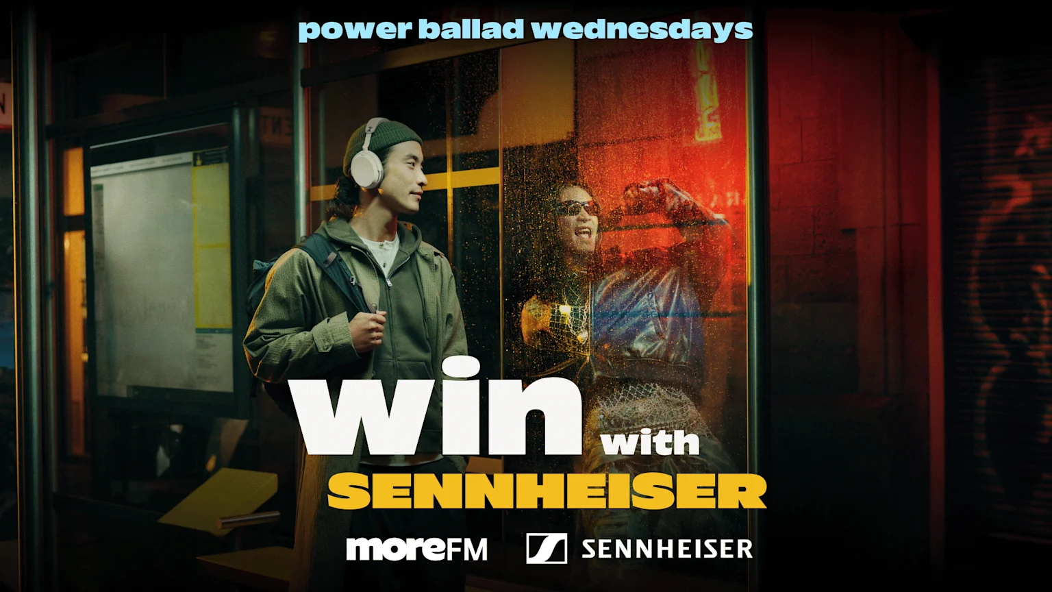 A man in Sennheiser headphones stands at a bus stop looking at an excited person behind a rainy window, with text "power ballad wednesdays" and "win with Sennheiser moreFM."