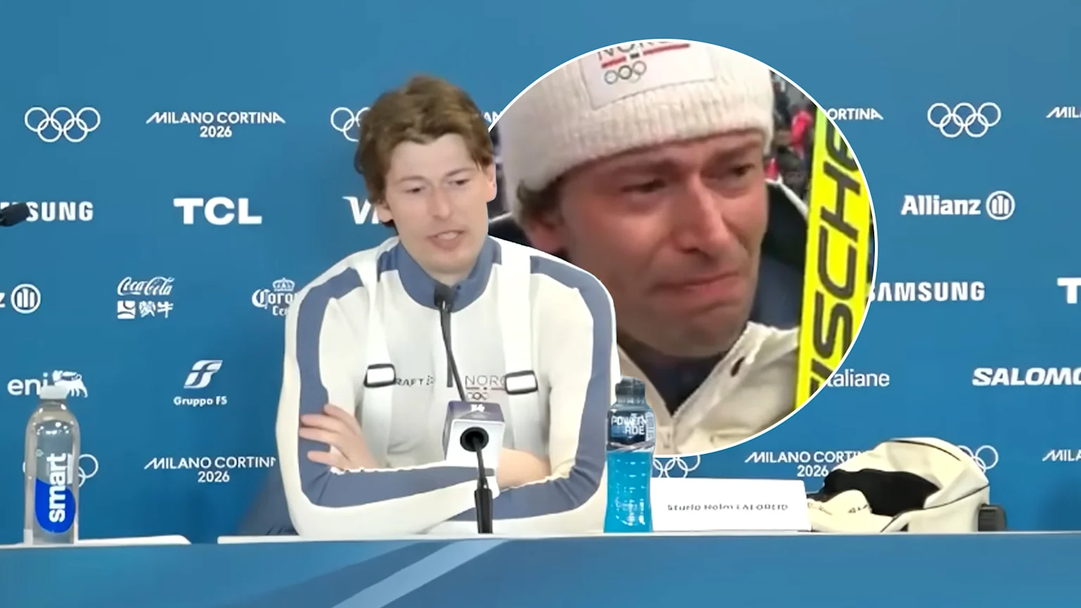 A young male athlete wearing Norway Olympic attire speaks at a press conference table with Milano Cortina 2026 sponsor logos in the background. An inset shows a man in distress wearing a white 'NOR' beanie holding a Fischer ski.