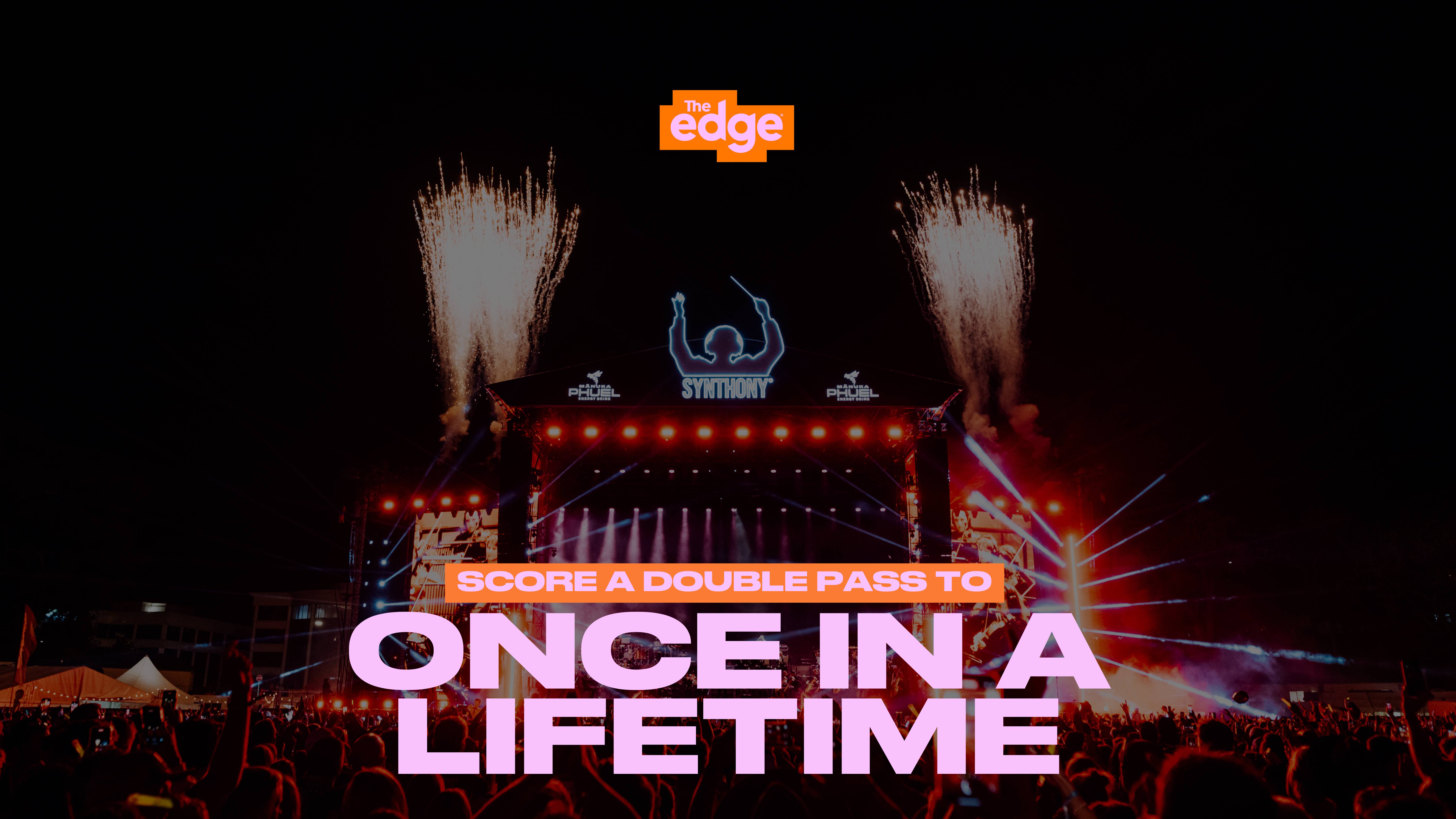 A dynamic outdoor concert at night with a large stage, bright lights, fireworks, and a crowd of people holding up their hands, overlaid with "The edge" logo and "SCORE A DOUBLE PASS TO ONCE IN A LIFETIME" text.