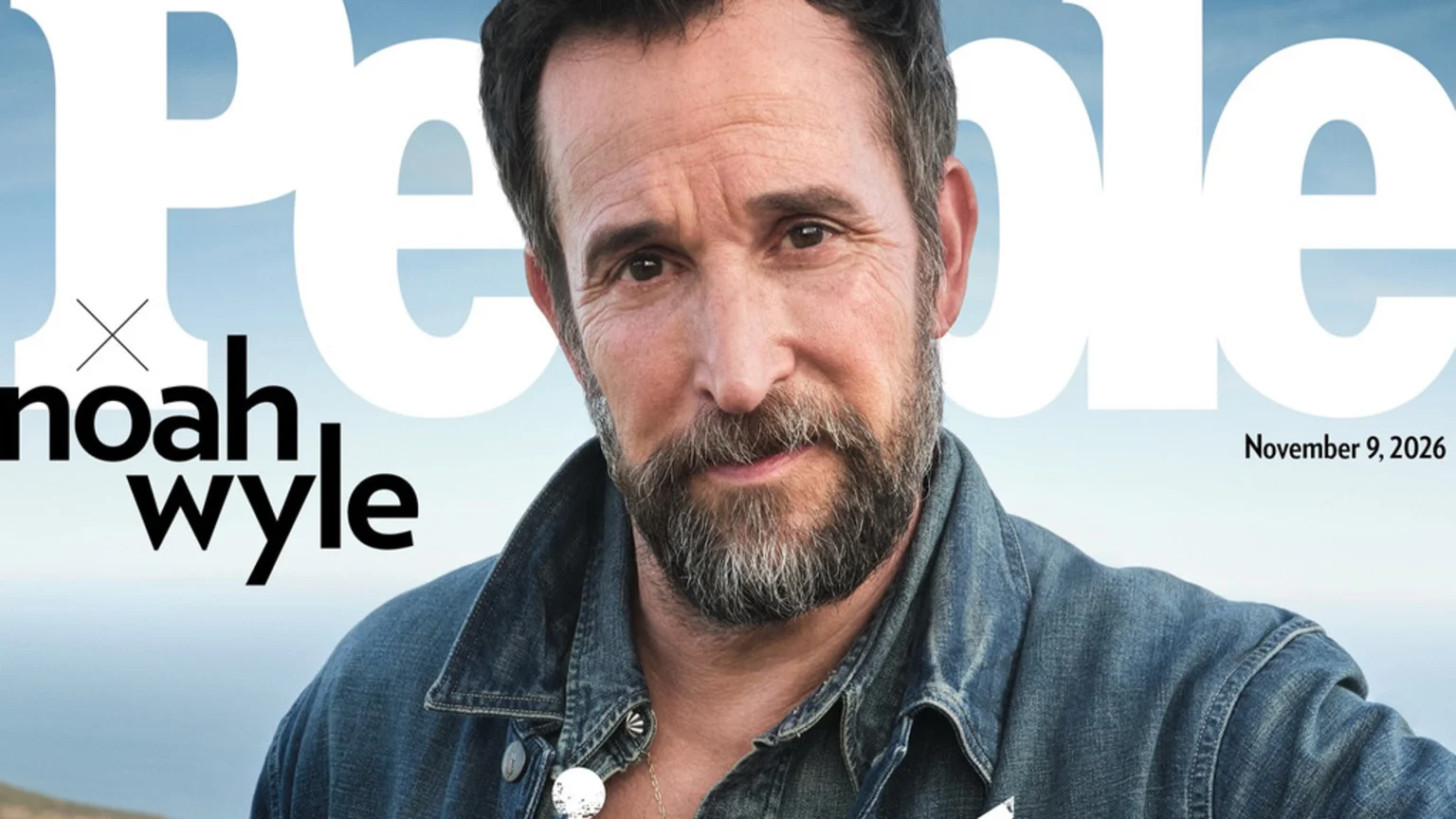 Actor Noah Wyle, with a beard and denim jacket, is featured on a People magazine cover dated November 9, 2026, with a light blue sky background.
