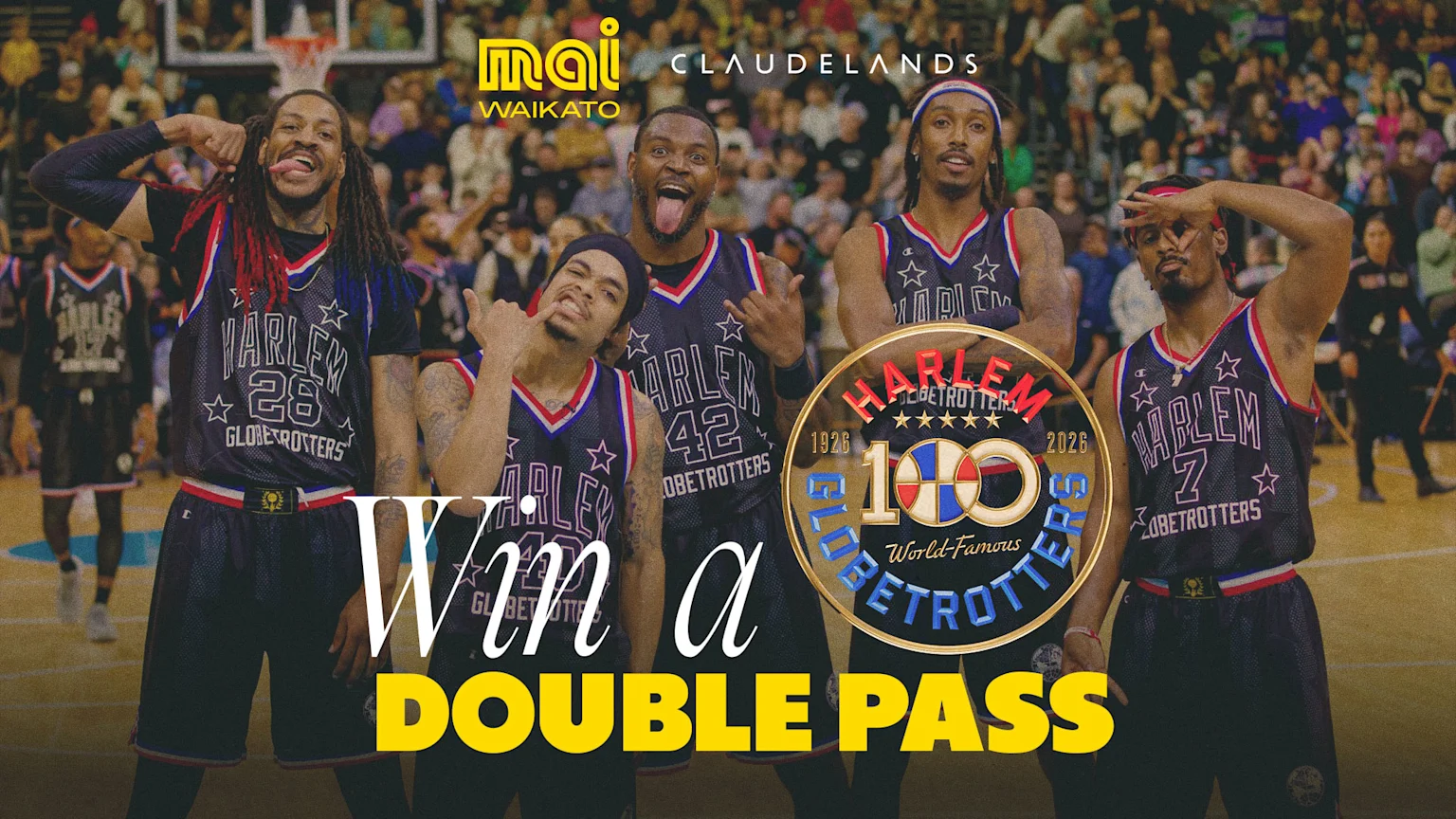 Five Harlem Globetrotters players making playful faces in uniform on a court, with a 100th anniversary logo and text "Win a DOUBLE PASS".