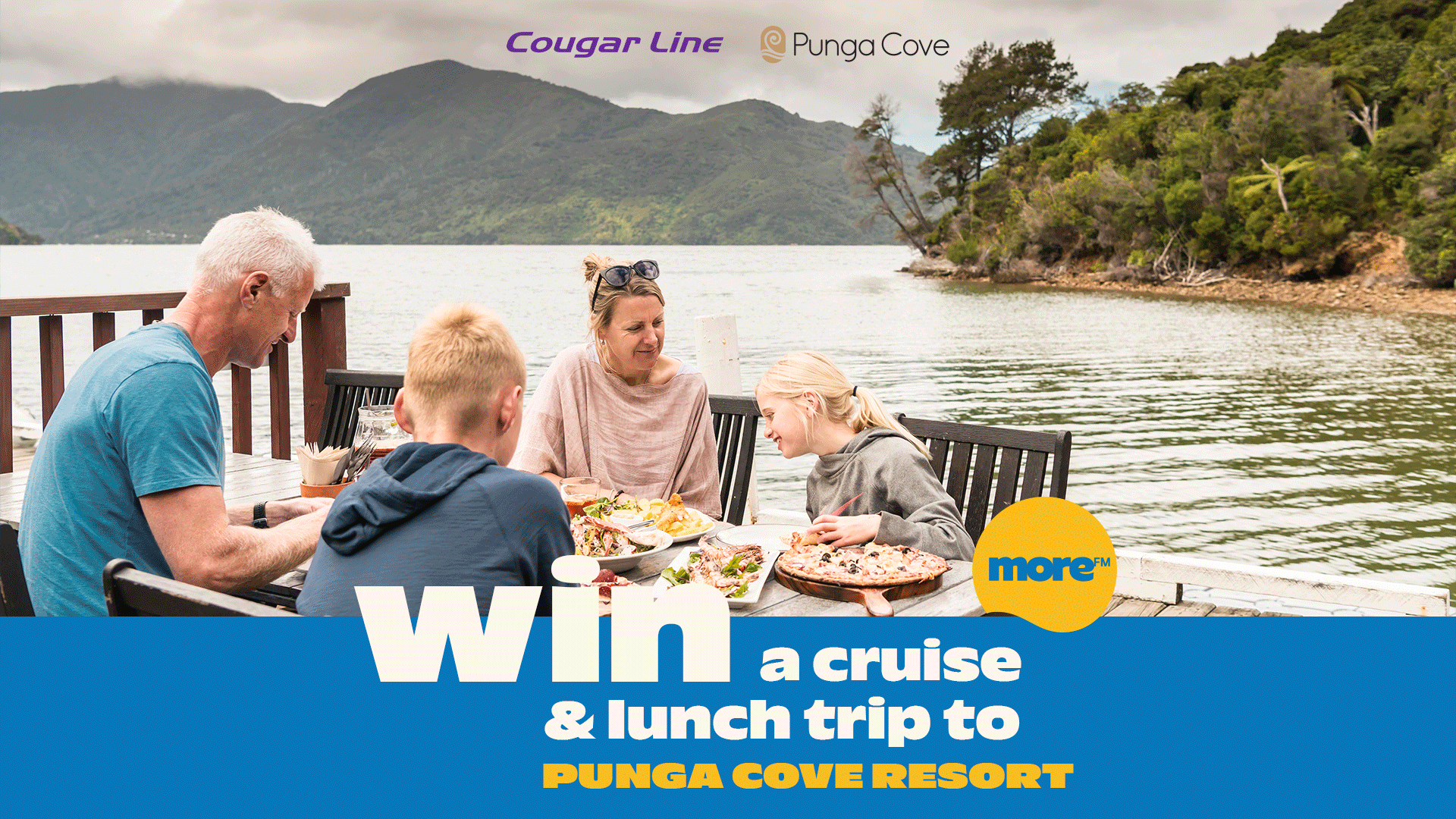 A family of four enjoys a meal on a deck overlooking a scenic bay with forested hills, with text promoting a "Win a cruise & lunch trip to Punga Cove Resort" competition.