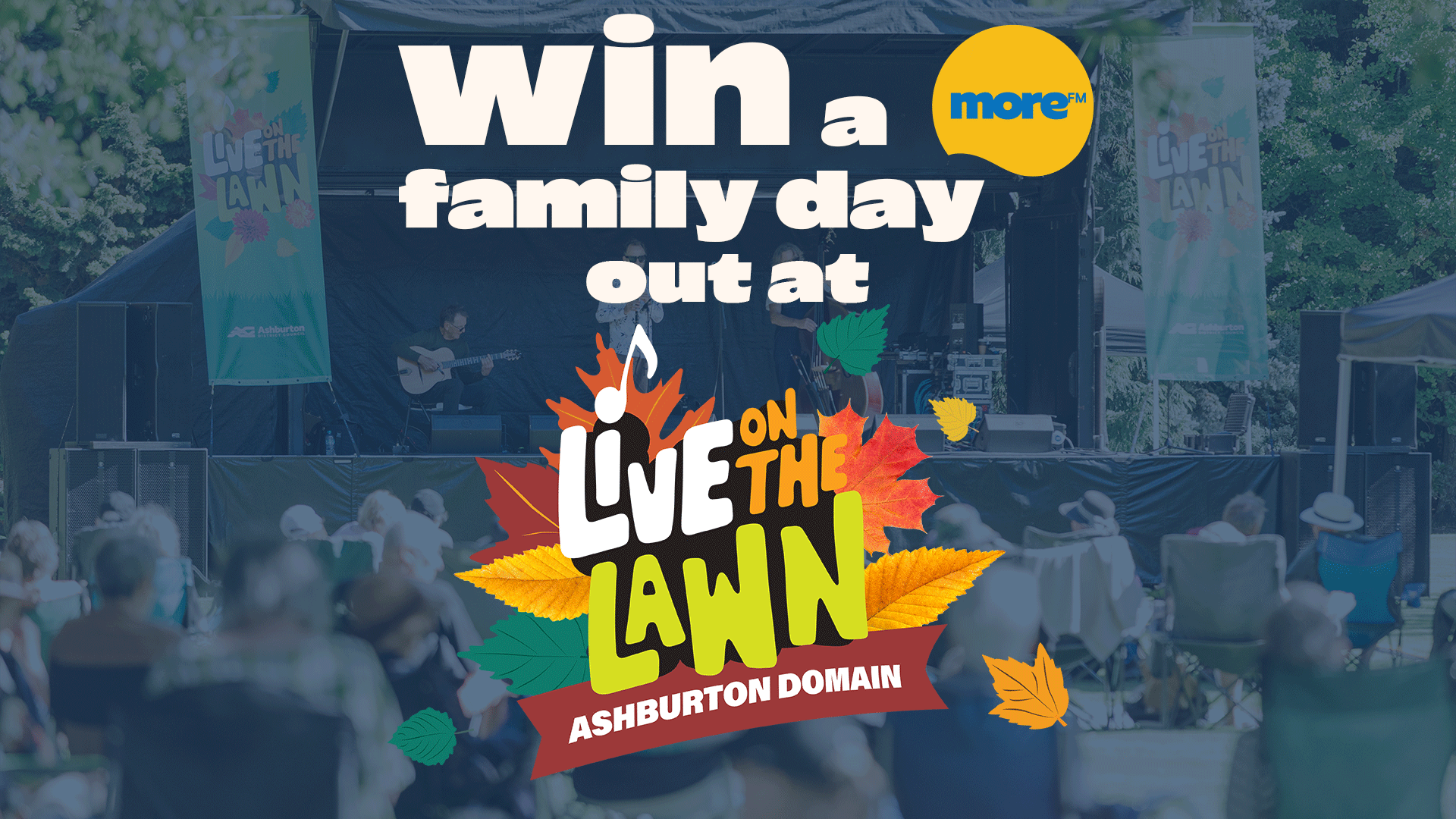 An outdoor concert with people watching a band on stage, overlaid with text "WIN a family day out at LIVE ON THE LAWN ASHBURTON DOMAIN" and the "more™" logo, decorated with autumn leaves.