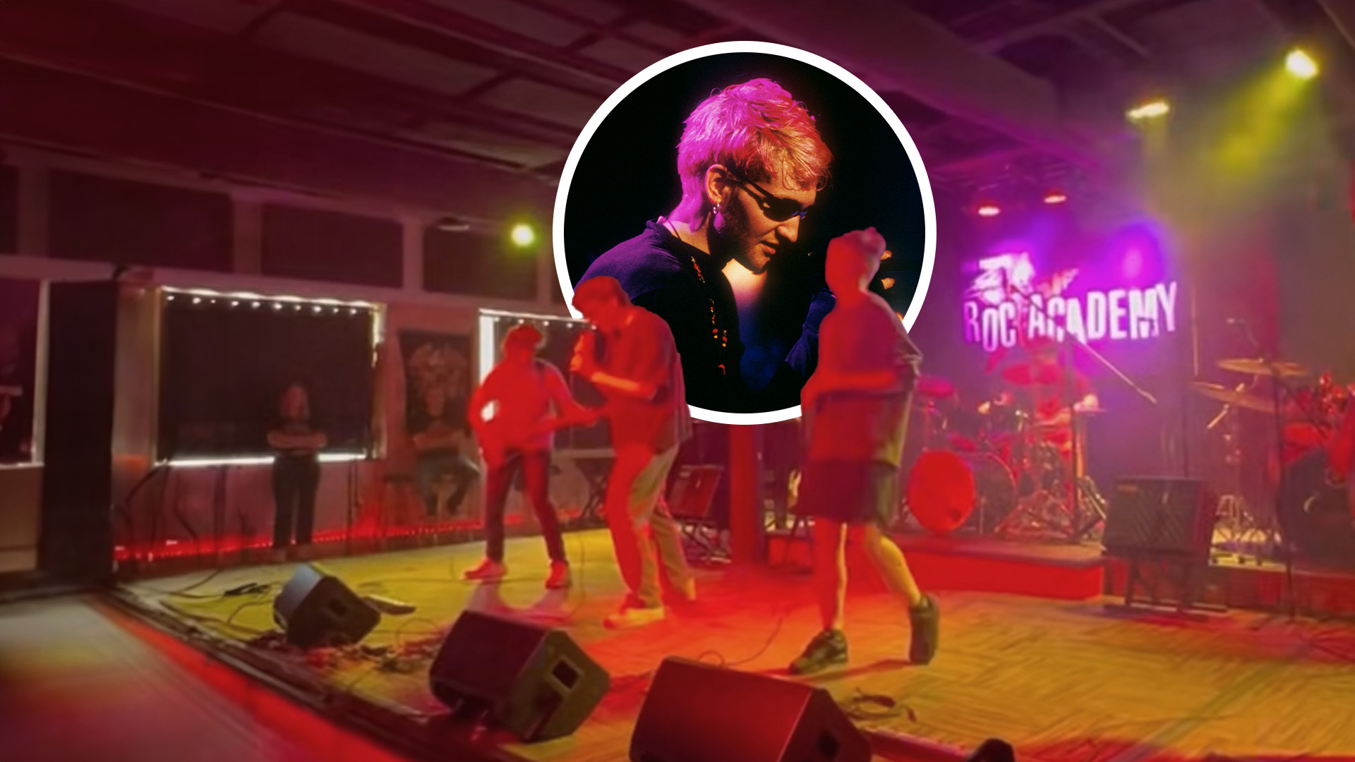 Teenagers on stage at rock camp, a circle with Layne Staley in it