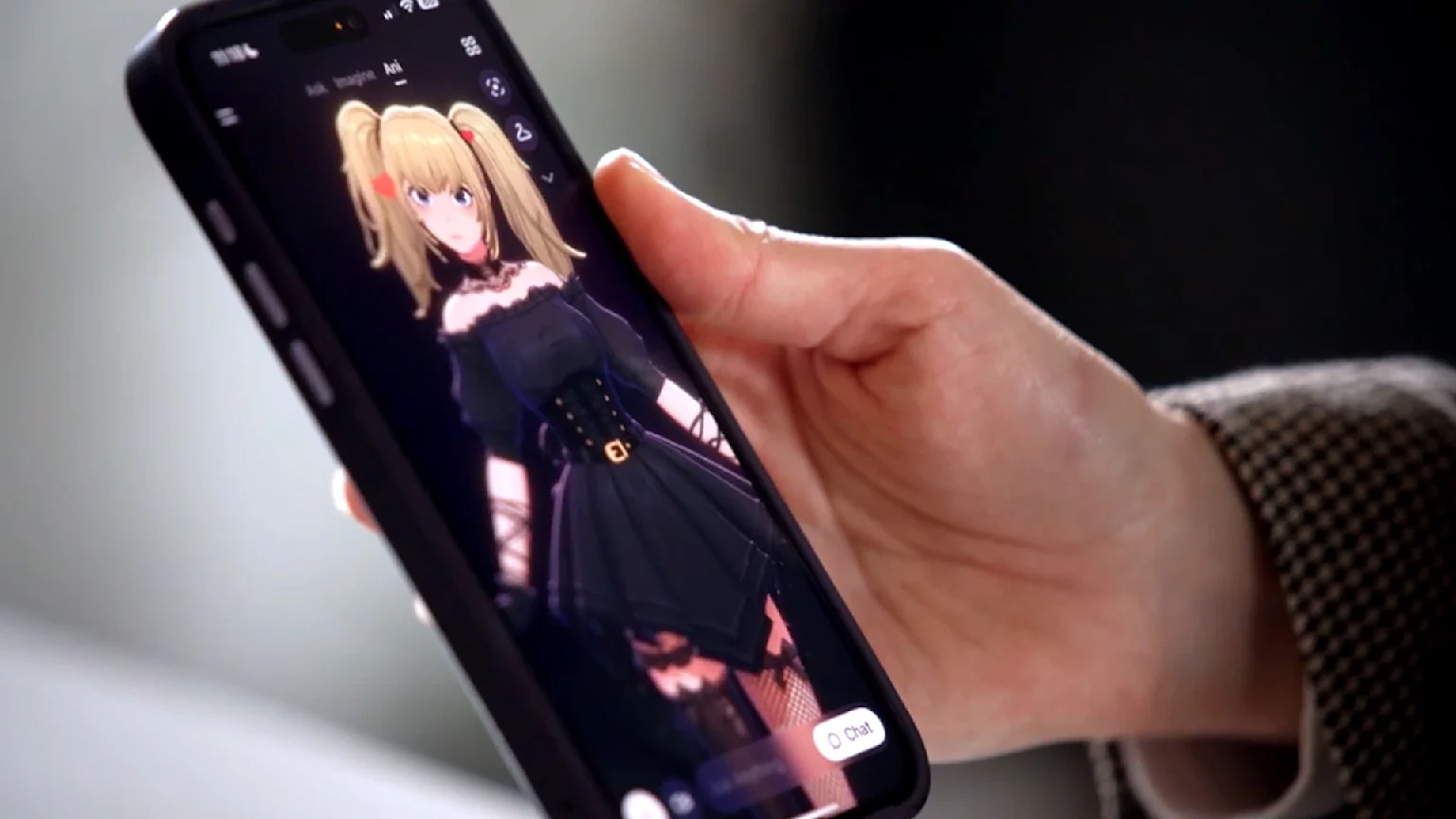 An image of Paddy Gower holding his phone with AI Chatbot Ani.