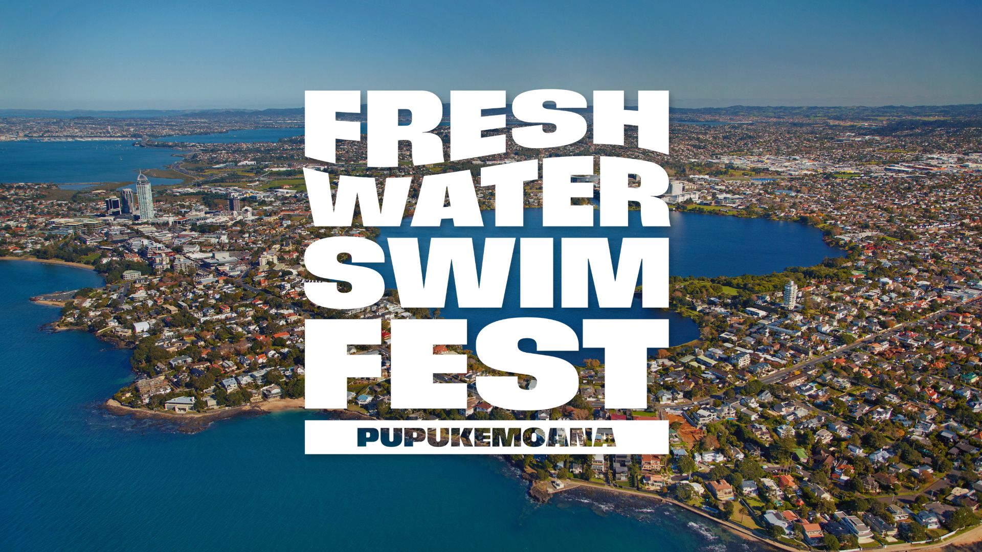 Aerial view of a city with a large freshwater lake and coastline, featuring prominent white text: "FRESH WATER SWIM FEST PUPUKEMOANA".