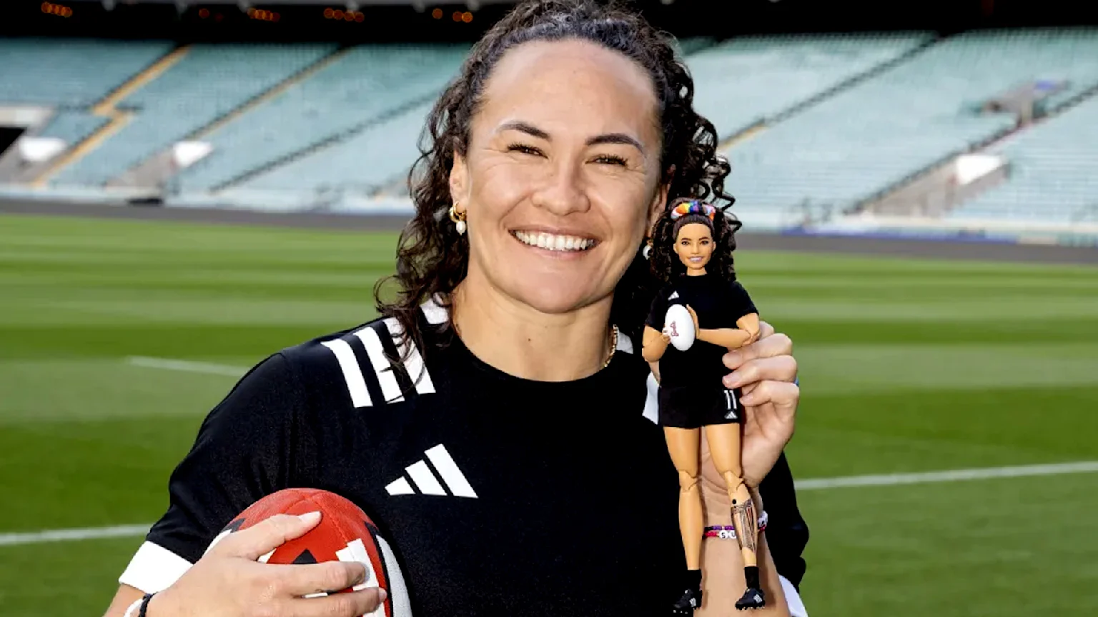 Portia Woodman-Wickliffe Holding her own Barbie doll