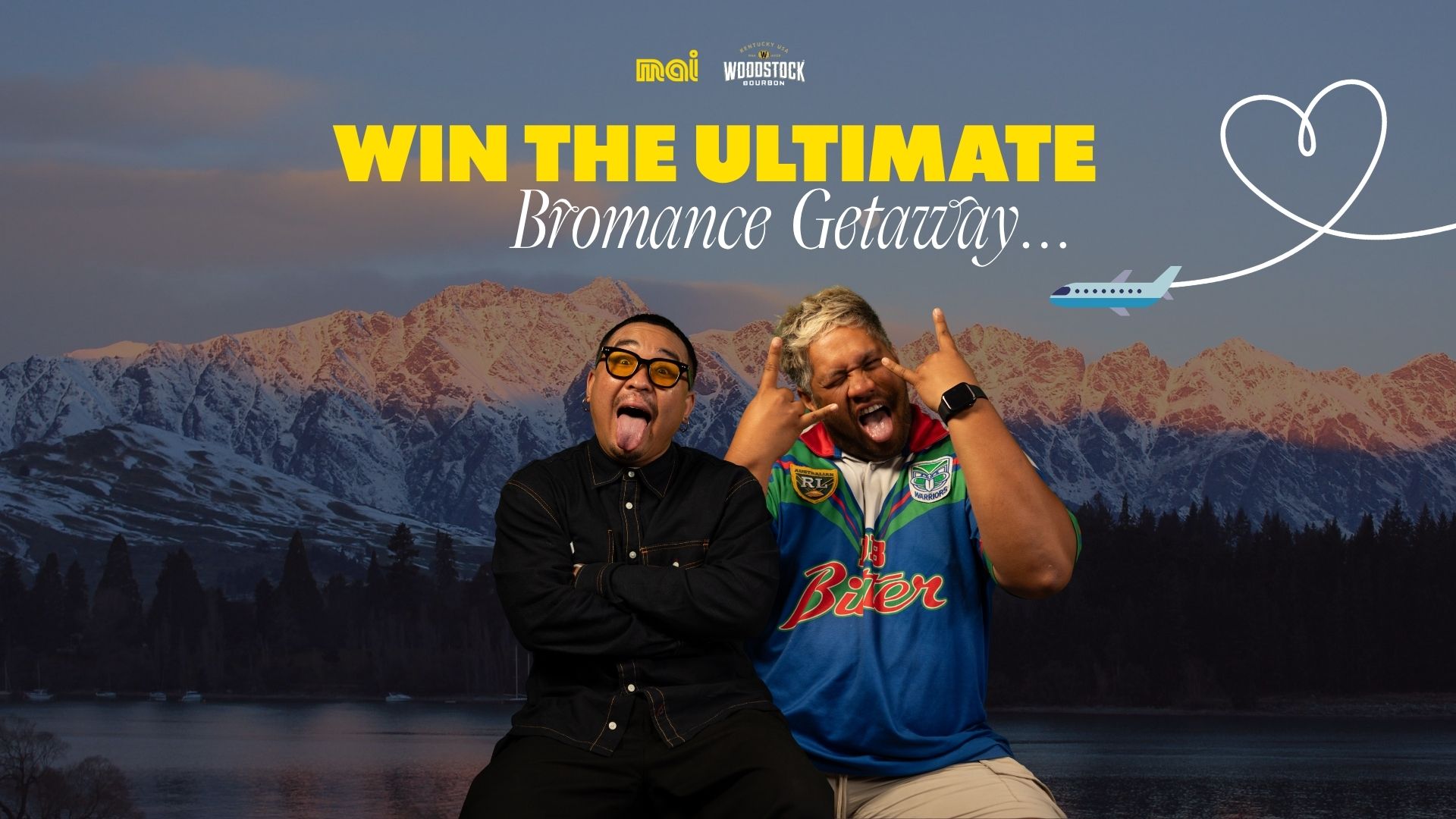 Two men make funny faces and gestures in front of a snowy mountain and lake backdrop, with text "WIN THE ULTIMATE Bromance Getaway" and a plane flying towards a heart-shaped path.
