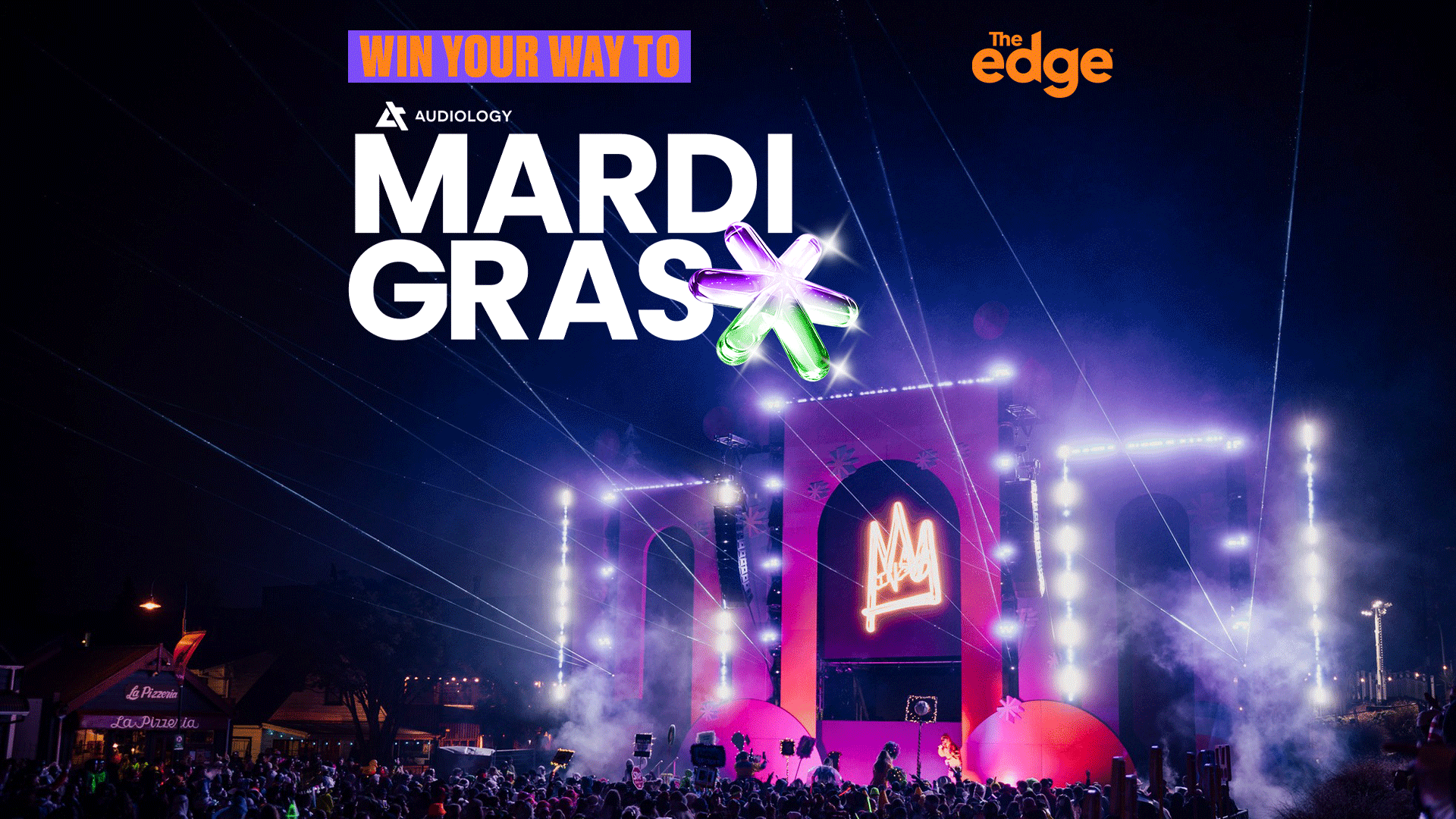A vibrant night festival with a large stage bathed in purple and pink lights, a crowd, and prominent text "WIN YOUR WAY TO MARDI GRAS" with a colorful star graphic, along with "Audiology" and "The Edge" branding.