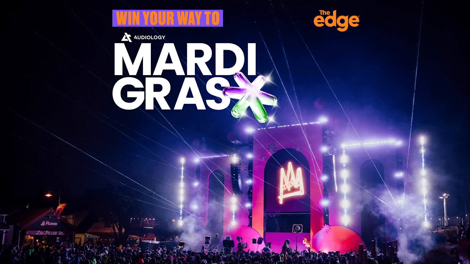 A vibrant night festival with a large stage bathed in purple and pink lights, a crowd, and prominent text "WIN YOUR WAY TO MARDI GRAS" with a colorful star graphic, along with "Audiology" and "The Edge" branding.