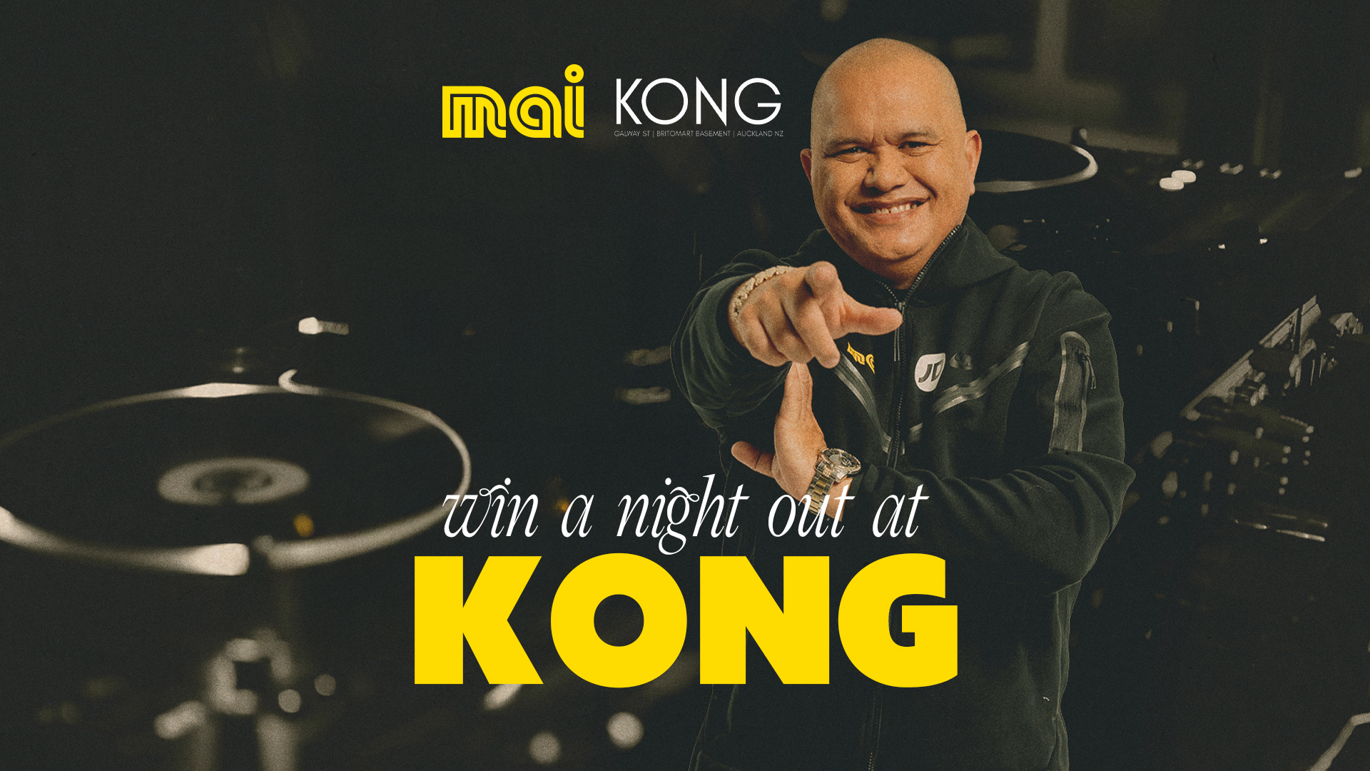 DJ decks with DJ Sir-Vere posing at camera. "Win a night out at Kong" with Mai FM.