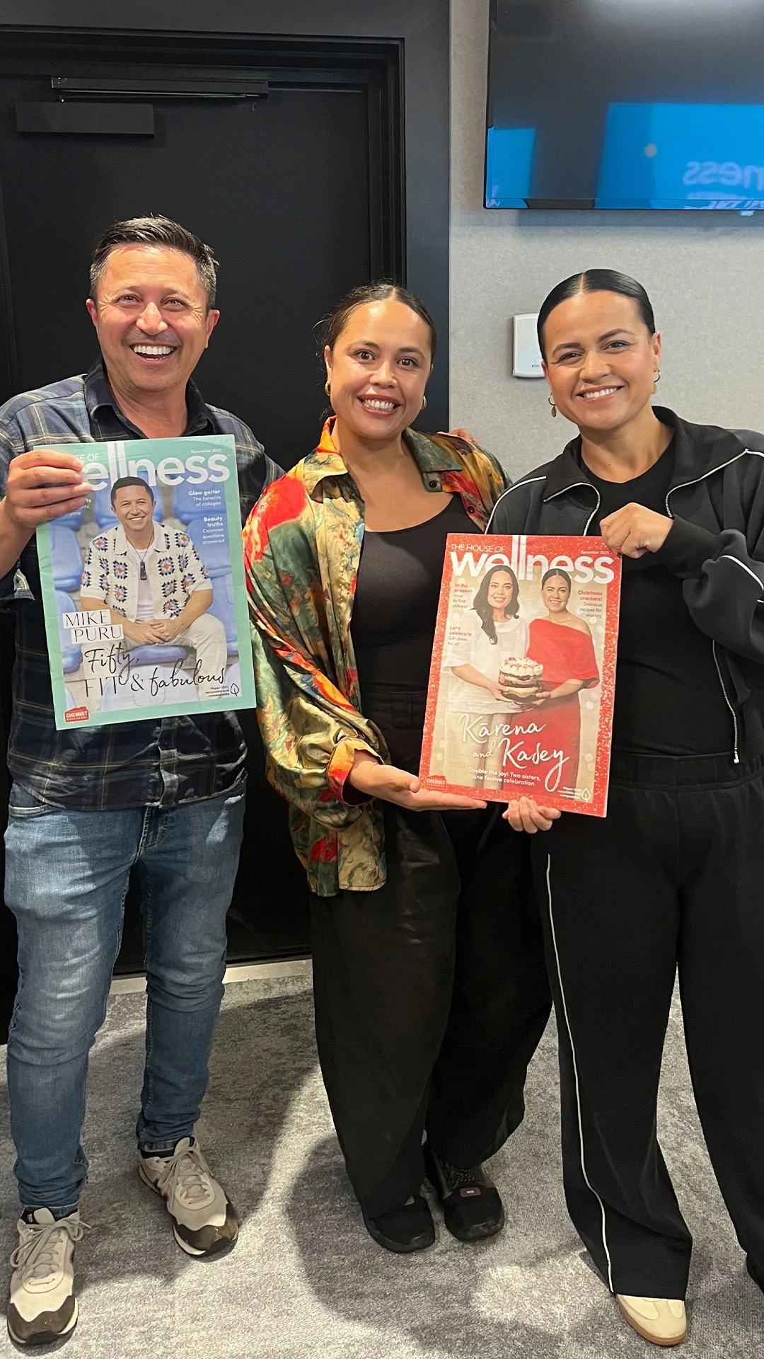Mike with Kārena and Kasey Bird, holding up their house of wellness magazines