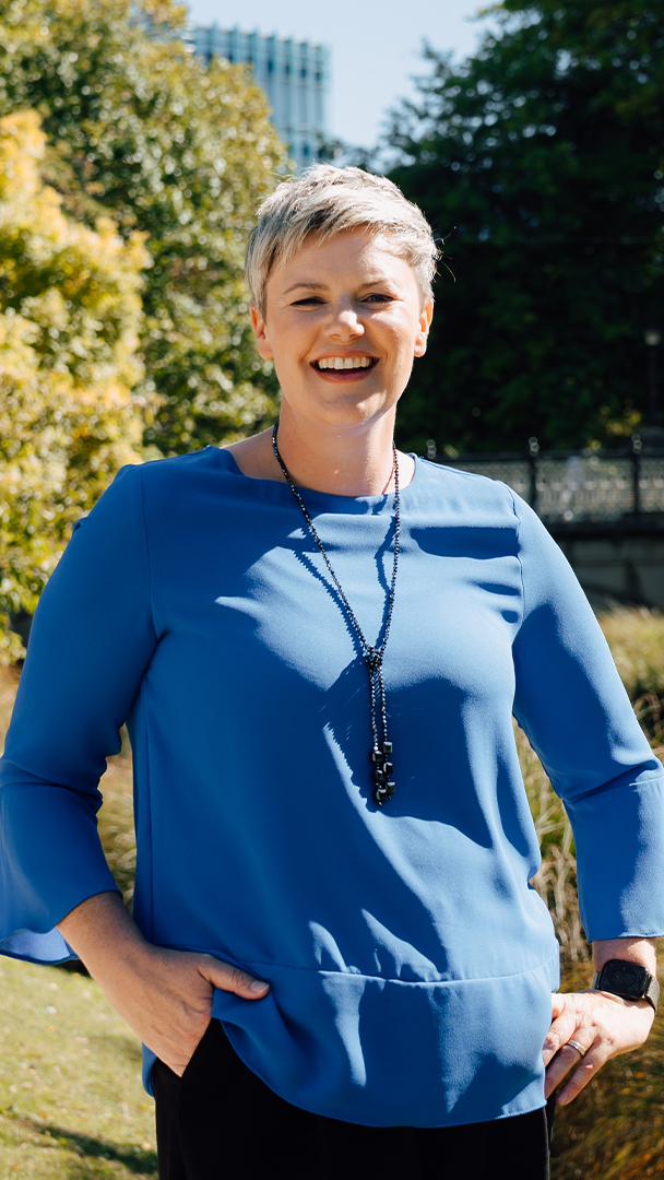 Sarah van der Kley standing with trees behind