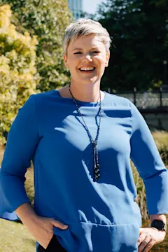 Sarah van der Kley standing with trees behind