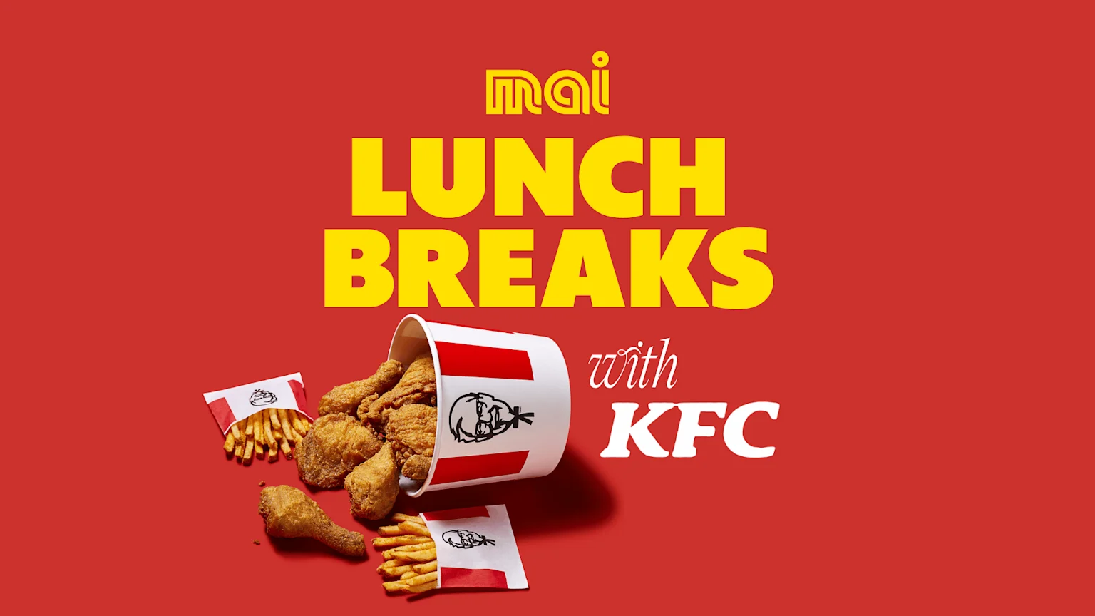 A red background with yellow "mai LUNCH BREAKS" and white "with KFC" text above a tipped KFC bucket overflowing with fried chicken and two bags of fries.
