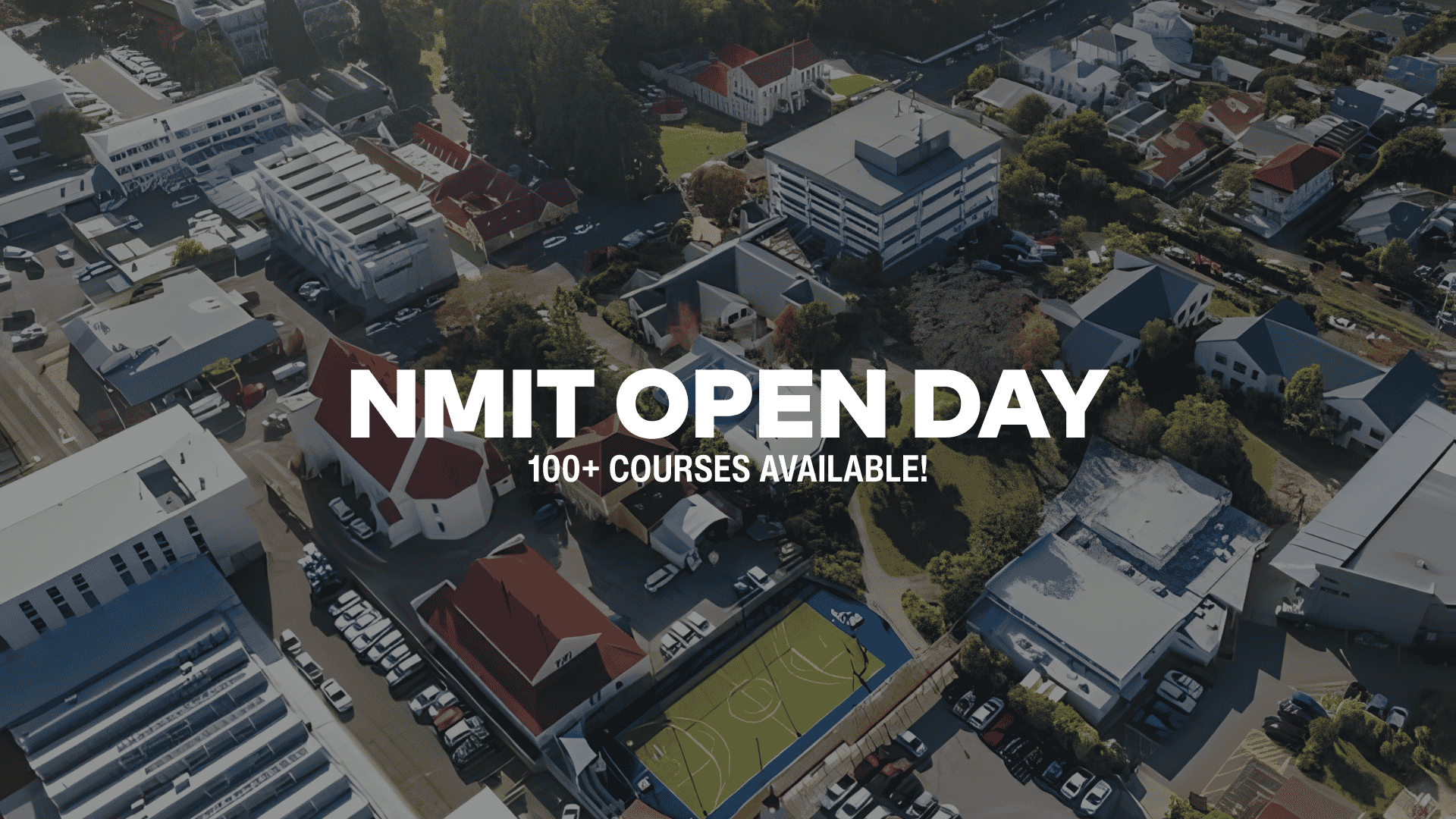 Aerial view of a school campus with various buildings, a basketball court, parked cars, and the text "NMIT OPEN DAY 100+ COURSES AVAILABLE!".