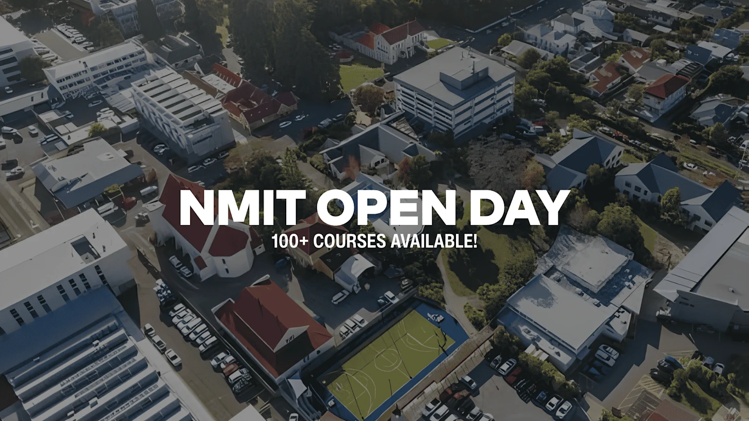 Aerial view of a school campus with various buildings, a basketball court, parked cars, and the text "NMIT OPEN DAY 100+ COURSES AVAILABLE!".