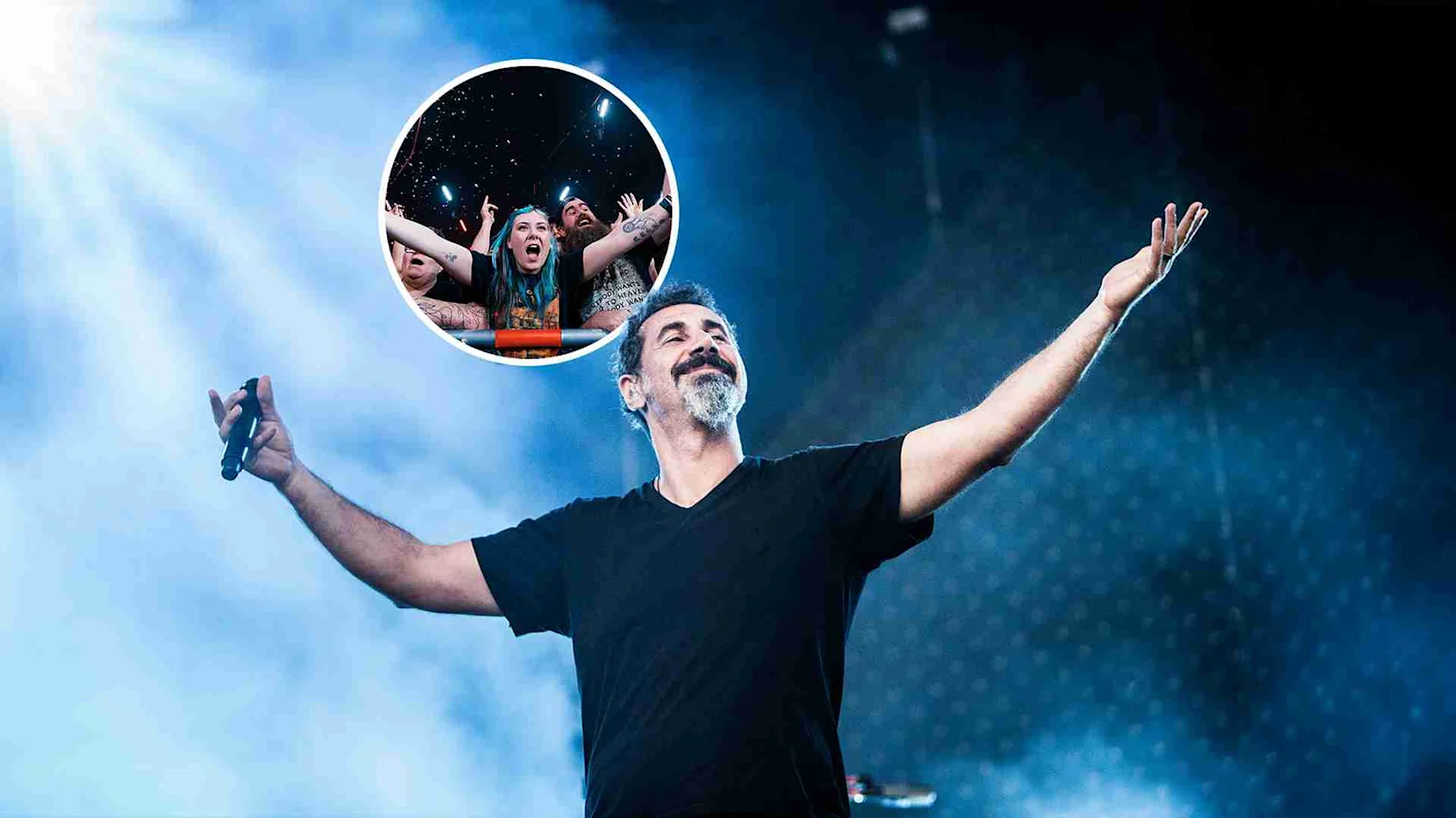 A bearded man on a smoky, blue-lit stage with arms outstretched, holding a microphone, smiling, with an inset of cheering concert fans in the top right.