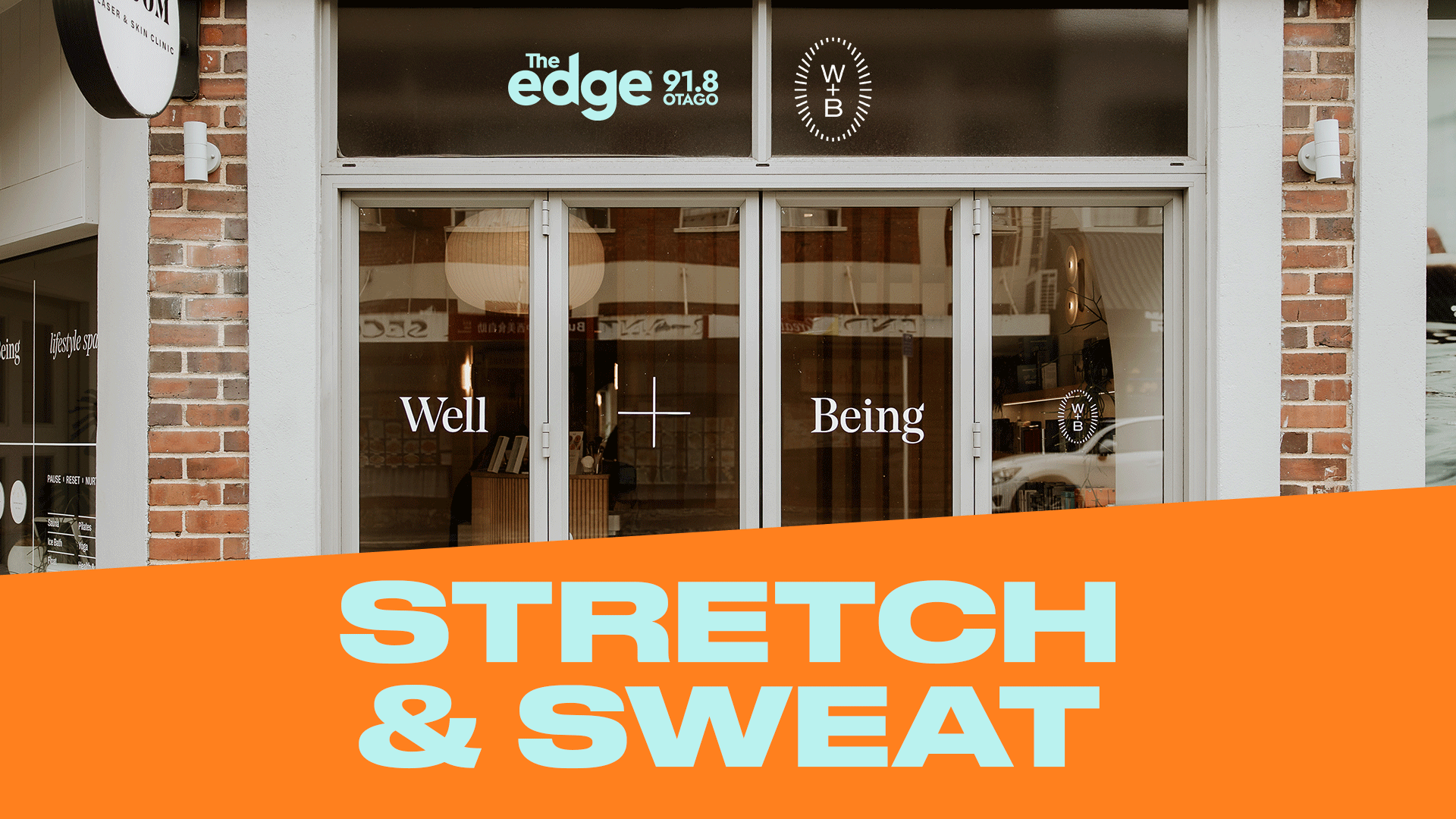 A building facade with windows displaying "Well" and "Being" text, "The Edge 91.8 OTAGO" and "W+B" logos, over an orange banner with "STRETCH & SWEAT" in light blue letters.