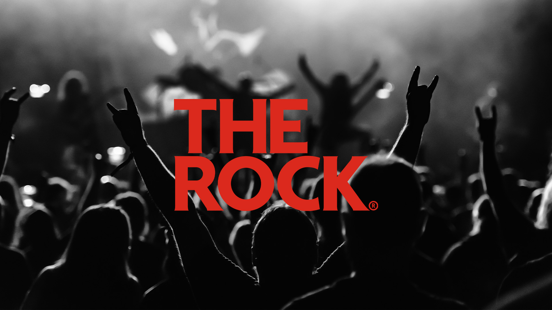 The Rock logo on top of a black and white image of a crowd at a rock concert
