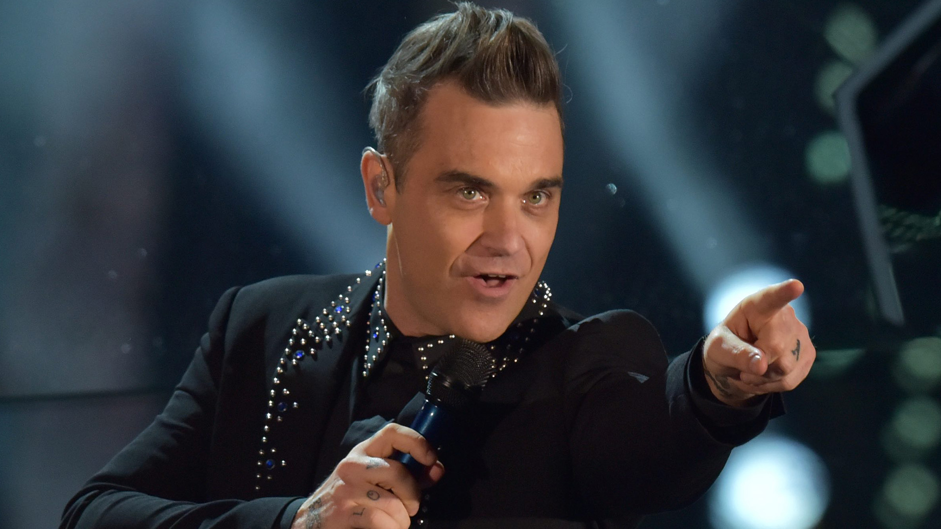 Robbie Williams performing on stage