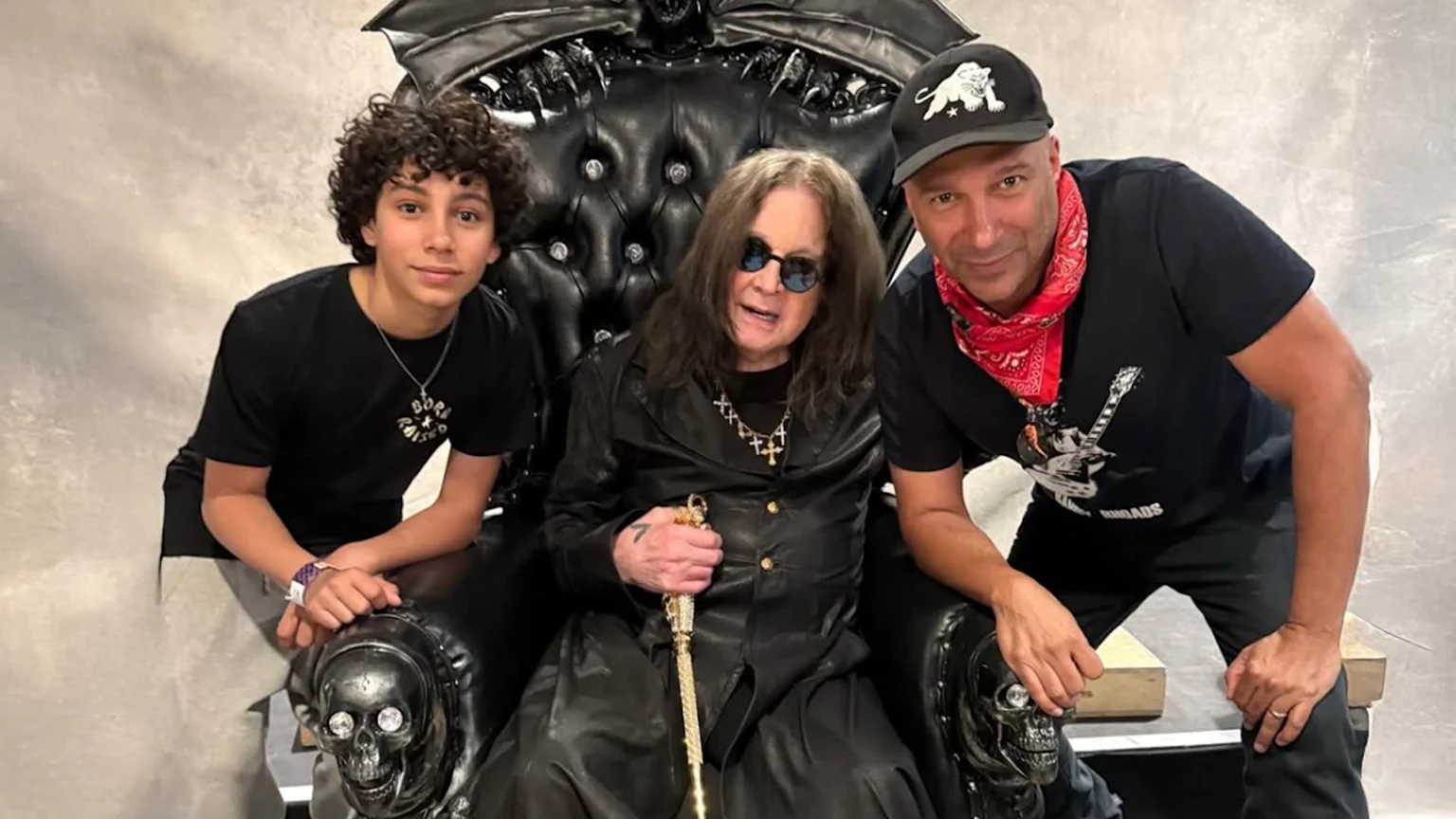 Tom Morello, Ozzy Osbourne and Roman Morello pose for the camera.